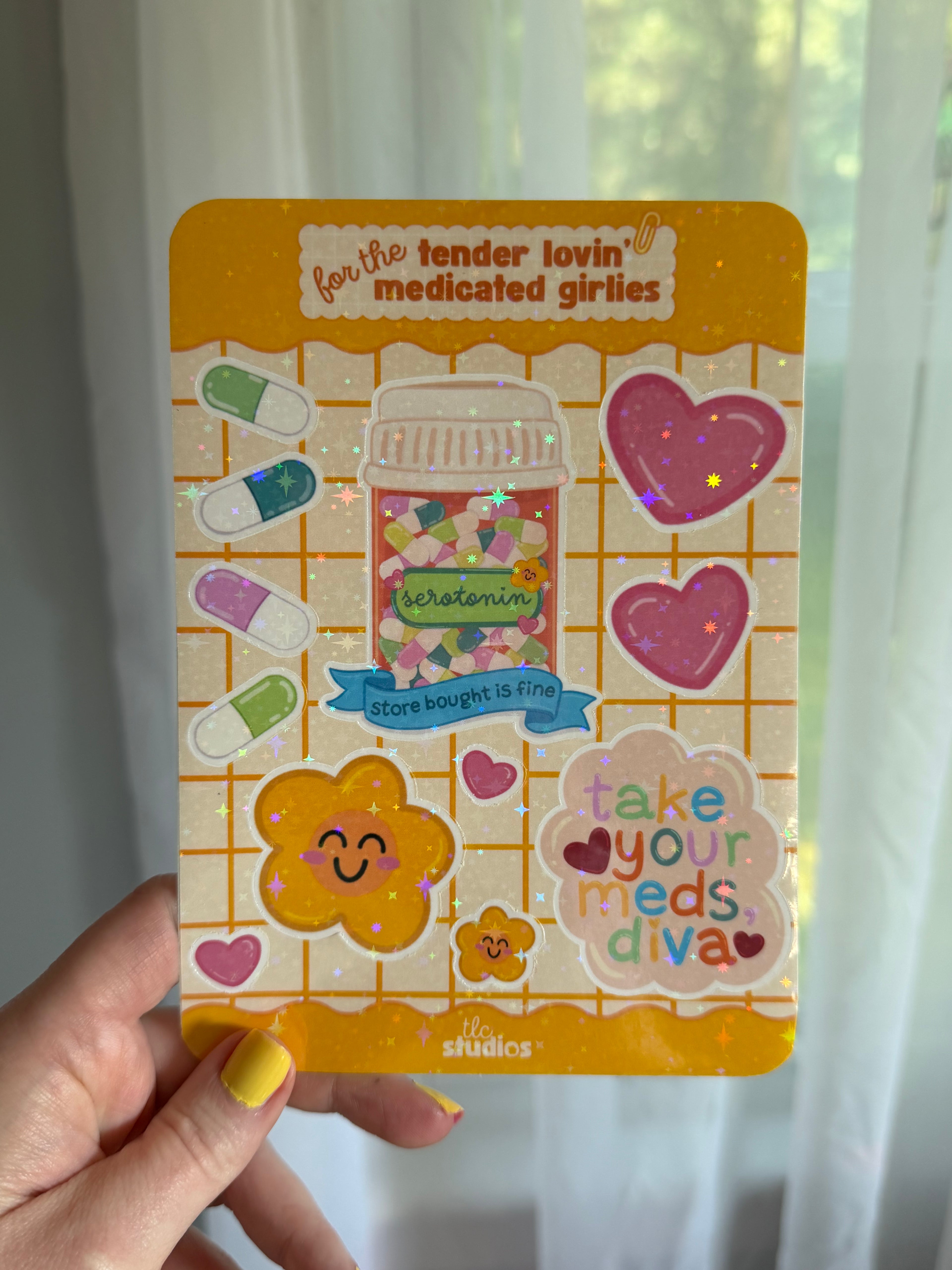 A rectangular sticker sheet with rounded corners featuring colorful cartoon medicine-themed designs, including pills, a pill bottle labeled 'serotonin,' hearts, a smiling flower, and phrases like 'take your meds diva.' Stickers are waterproof & holographic.